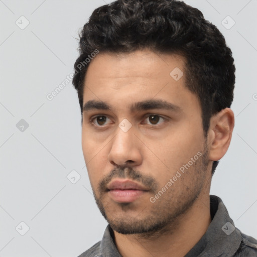 Neutral latino young-adult male with short  black hair and brown eyes