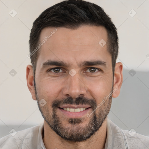 Joyful white adult male with short  black hair and brown eyes