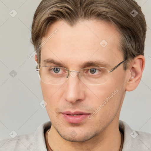 Joyful white adult male with short  brown hair and grey eyes