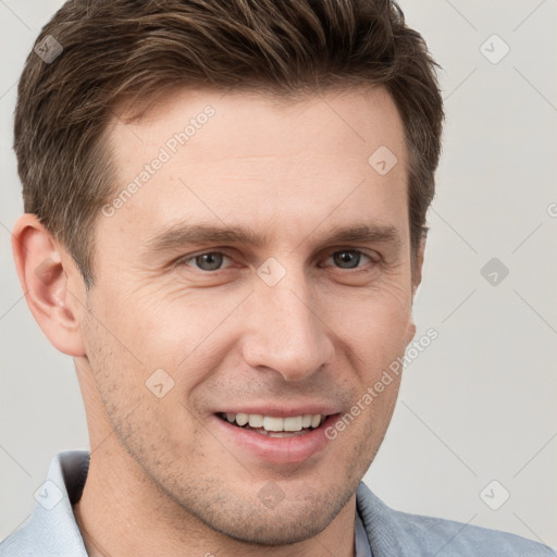 Joyful white young-adult male with short  brown hair and grey eyes