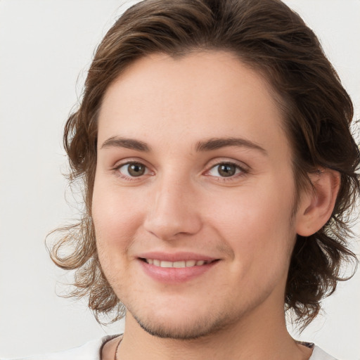 Joyful white young-adult female with medium  brown hair and green eyes