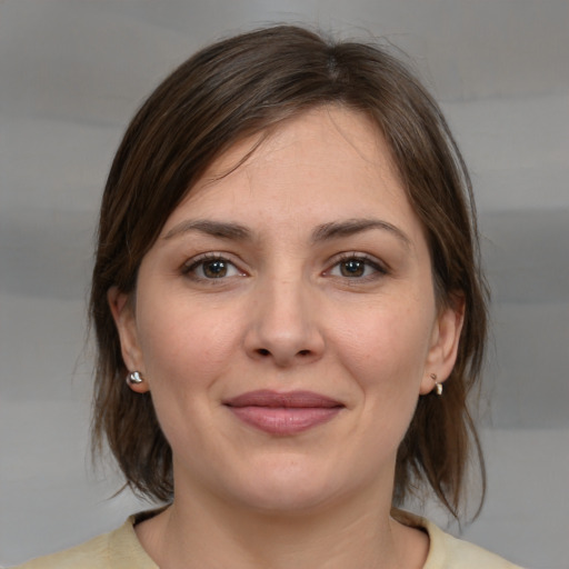 Joyful white young-adult female with medium  brown hair and brown eyes