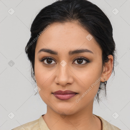 Joyful latino young-adult female with medium  brown hair and brown eyes