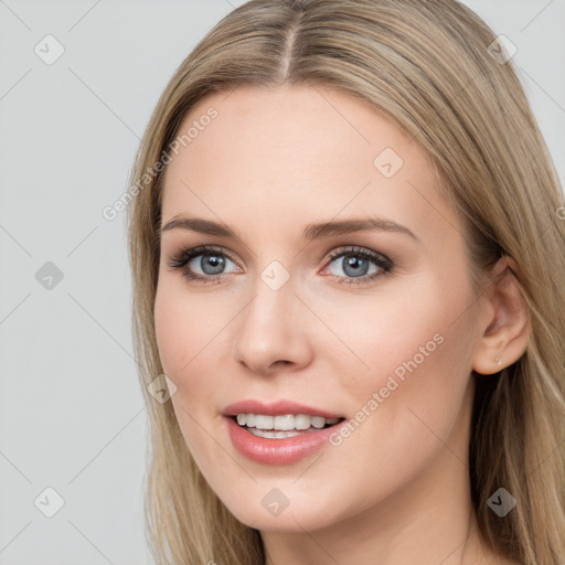 Joyful white young-adult female with long  brown hair and grey eyes