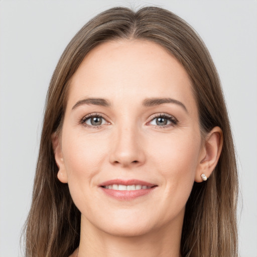 Joyful white young-adult female with long  brown hair and grey eyes