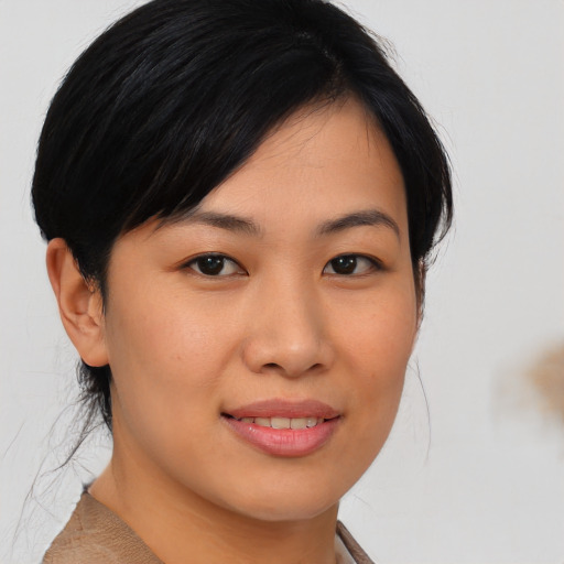 Joyful asian young-adult female with medium  brown hair and brown eyes