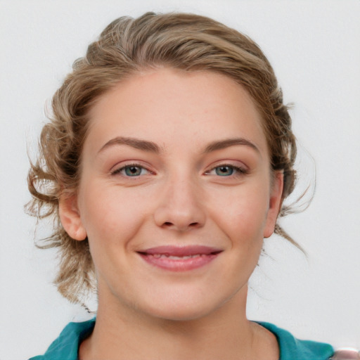 Joyful white young-adult female with medium  brown hair and blue eyes