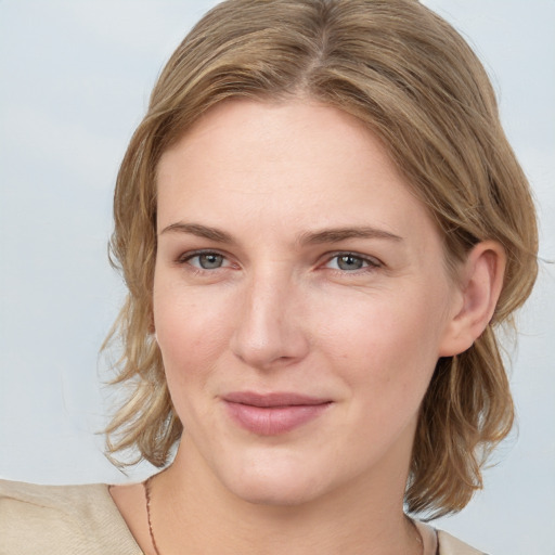 Joyful white young-adult female with medium  brown hair and blue eyes