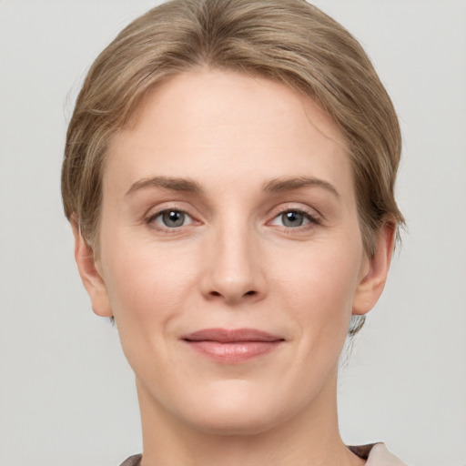 Joyful white young-adult female with short  brown hair and grey eyes