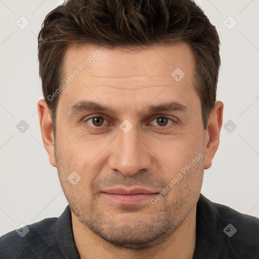 Joyful white adult male with short  brown hair and brown eyes