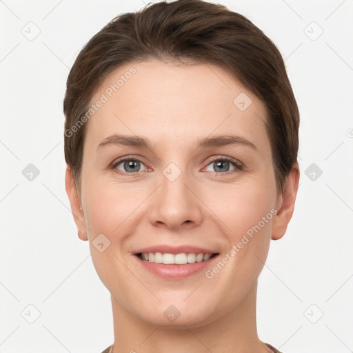 Joyful white young-adult female with short  brown hair and grey eyes