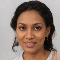 Joyful black young-adult female with medium  brown hair and brown eyes