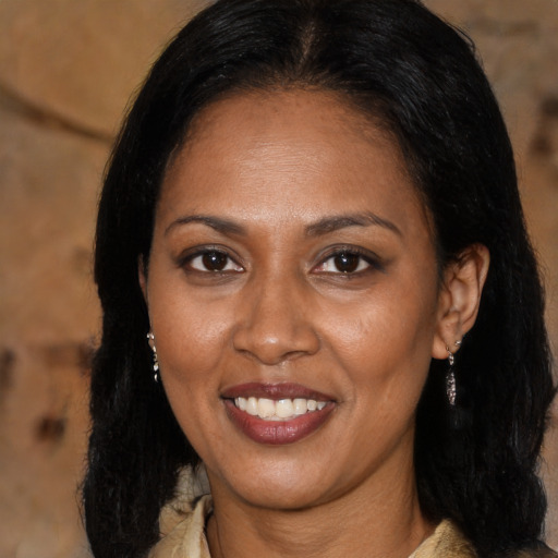 Joyful latino adult female with medium  black hair and brown eyes