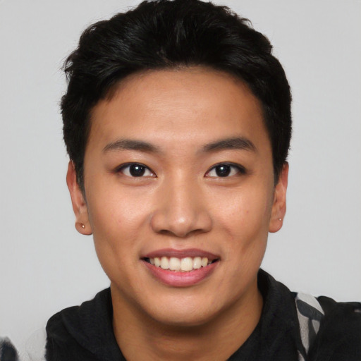 Joyful asian young-adult male with short  black hair and brown eyes