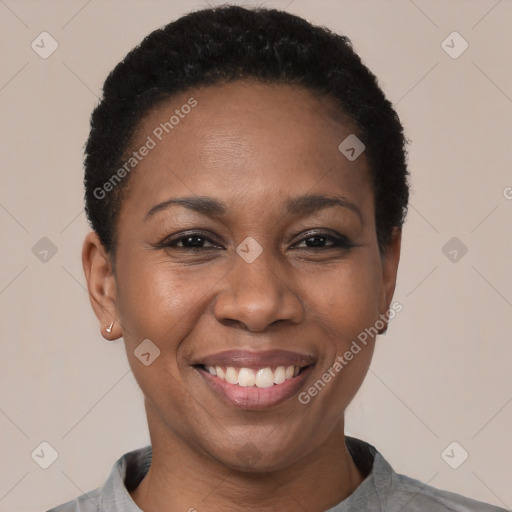 Joyful black young-adult female with short  black hair and brown eyes