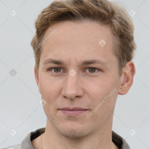 Joyful white adult male with short  brown hair and grey eyes