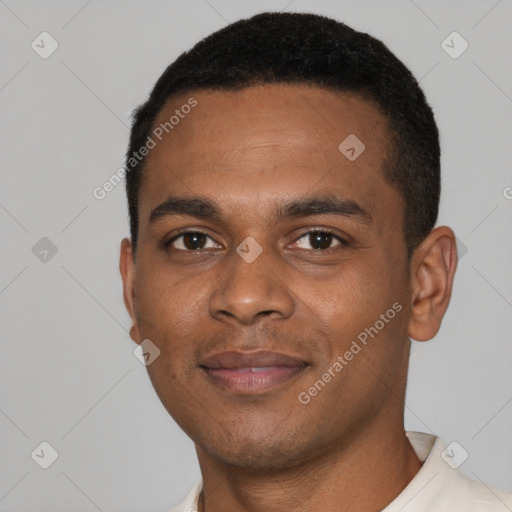 Joyful black young-adult male with short  black hair and brown eyes