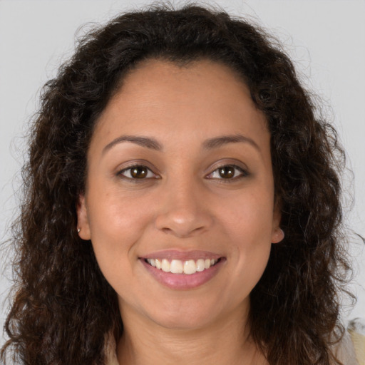 Joyful white young-adult female with long  brown hair and brown eyes