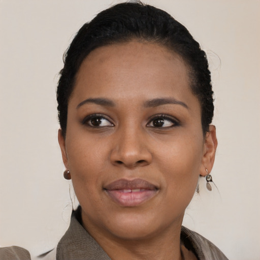 Joyful black young-adult female with short  black hair and brown eyes