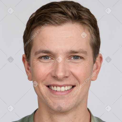 Joyful white adult male with short  brown hair and grey eyes