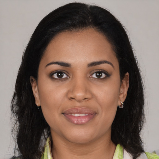 Joyful black young-adult female with medium  black hair and brown eyes