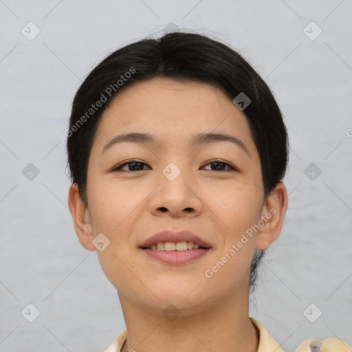 Joyful asian young-adult female with short  brown hair and brown eyes