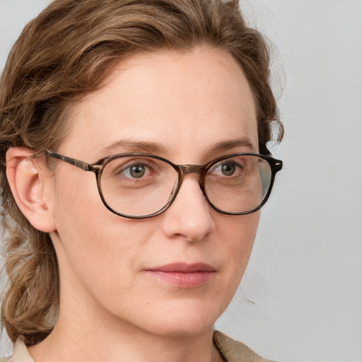 Joyful white adult female with medium  brown hair and blue eyes