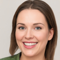 Joyful white young-adult female with medium  brown hair and green eyes