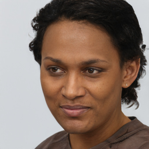 Joyful black adult female with short  brown hair and brown eyes