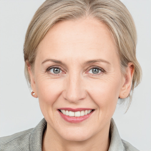 Joyful white adult female with medium  brown hair and blue eyes