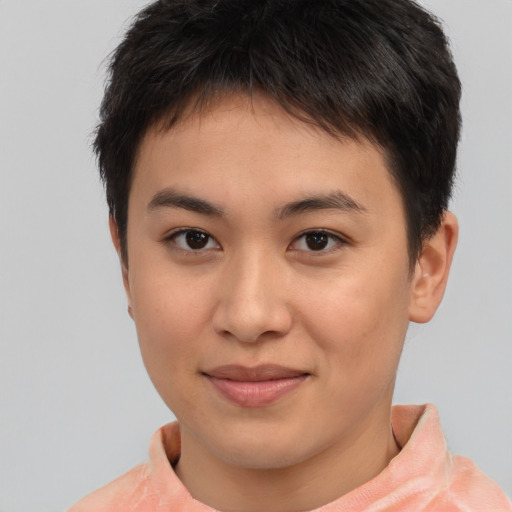 Joyful asian young-adult female with short  brown hair and brown eyes
