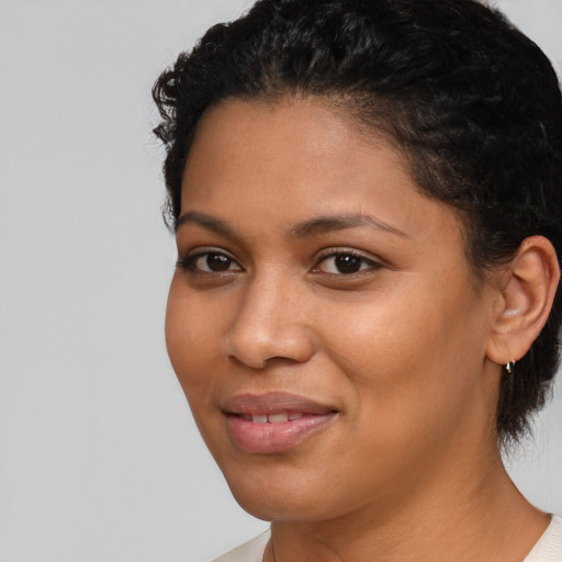 Joyful latino young-adult female with short  black hair and brown eyes