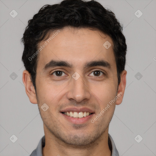 Joyful white young-adult male with short  black hair and brown eyes