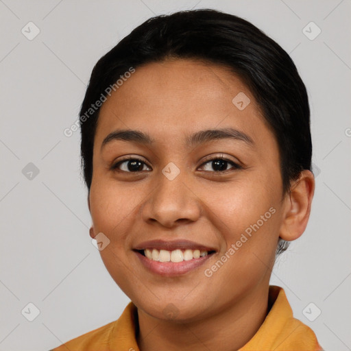 Joyful latino young-adult female with short  black hair and brown eyes