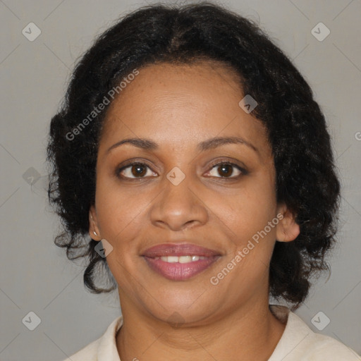 Joyful black adult female with medium  brown hair and brown eyes