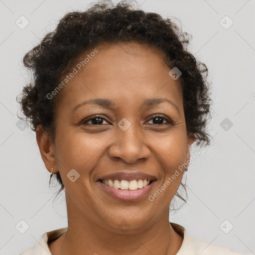 Joyful black adult female with short  brown hair and brown eyes