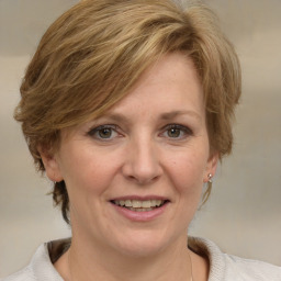 Joyful white adult female with medium  brown hair and grey eyes