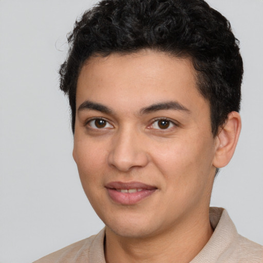 Joyful latino young-adult male with short  brown hair and brown eyes