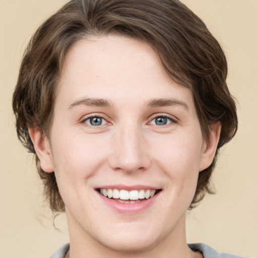 Joyful white young-adult female with medium  brown hair and green eyes