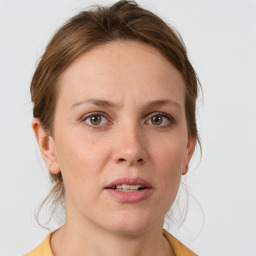 Joyful white young-adult female with medium  brown hair and blue eyes