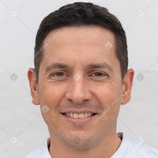 Joyful white adult male with short  brown hair and brown eyes