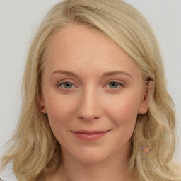 Joyful white young-adult female with long  brown hair and blue eyes