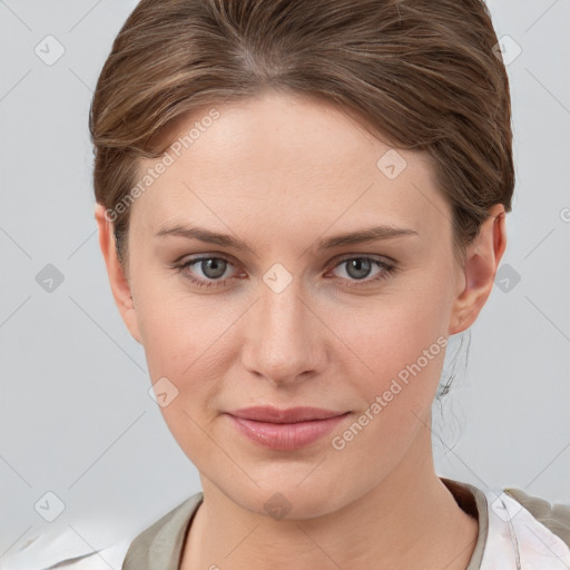 Joyful white young-adult female with medium  brown hair and grey eyes