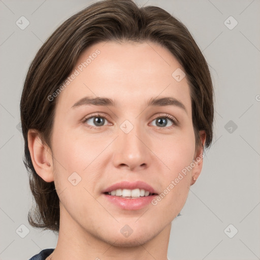 Joyful white young-adult female with short  brown hair and grey eyes