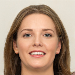 Joyful white young-adult female with long  brown hair and green eyes