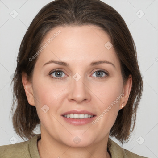 Joyful white adult female with medium  brown hair and grey eyes