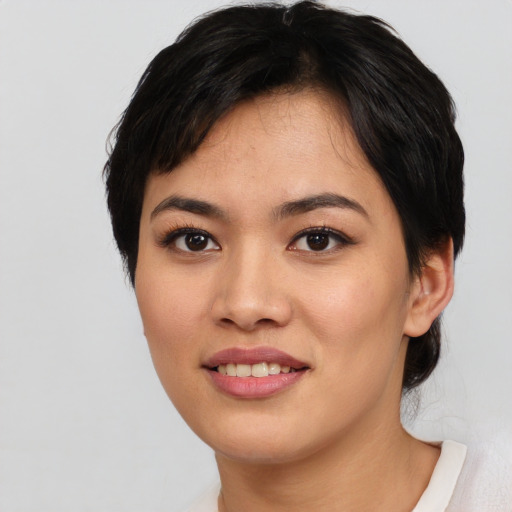 Joyful asian young-adult female with short  black hair and brown eyes