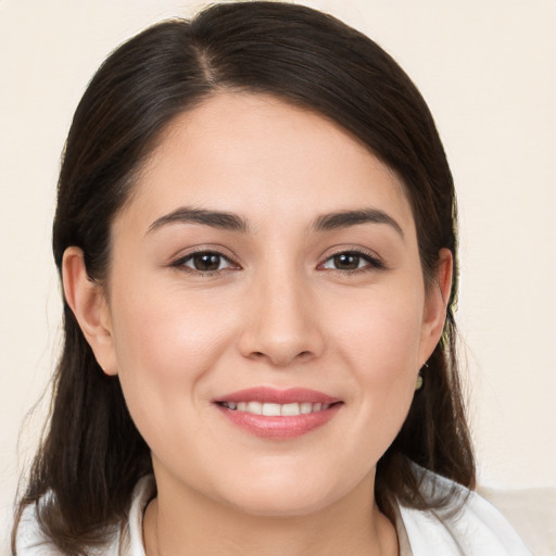 Joyful white young-adult female with medium  brown hair and brown eyes