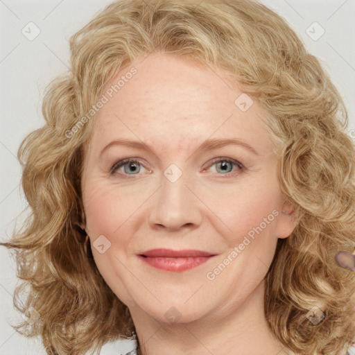 Joyful white adult female with medium  brown hair and blue eyes