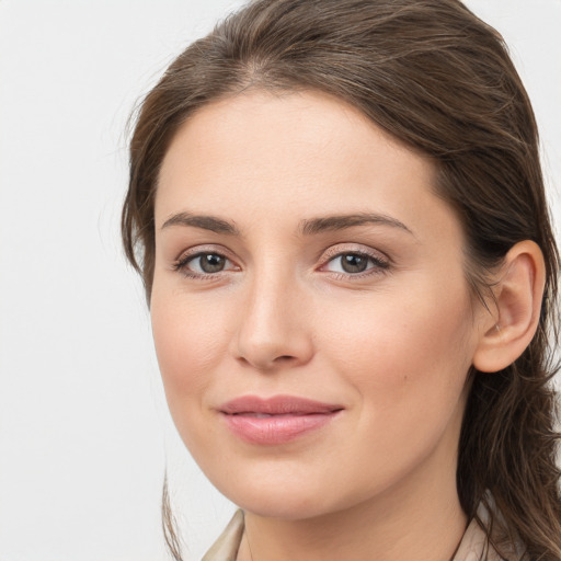 Joyful white young-adult female with long  brown hair and grey eyes